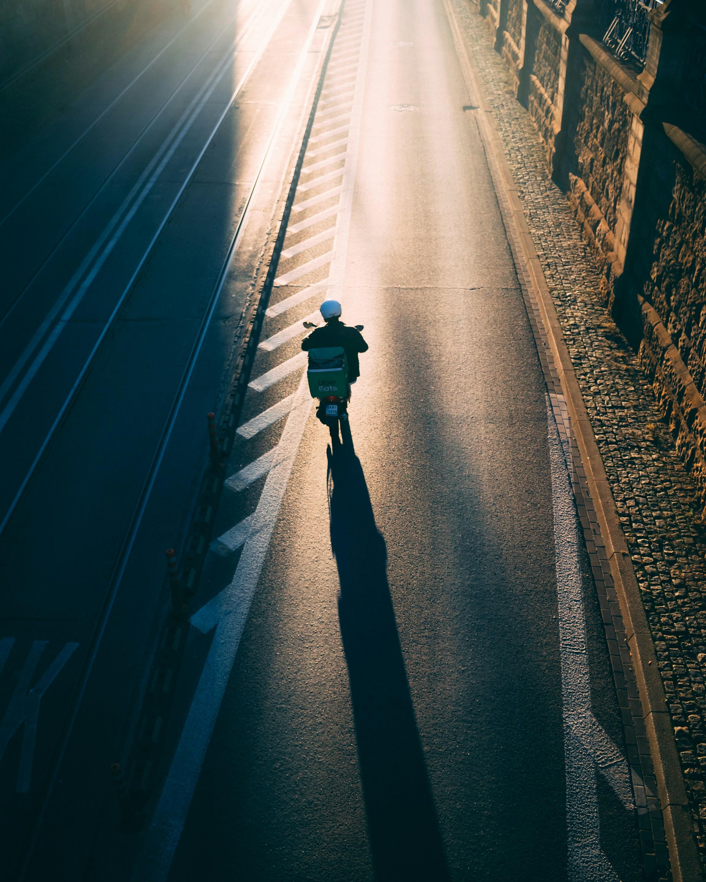 Delivery person on road aerial view